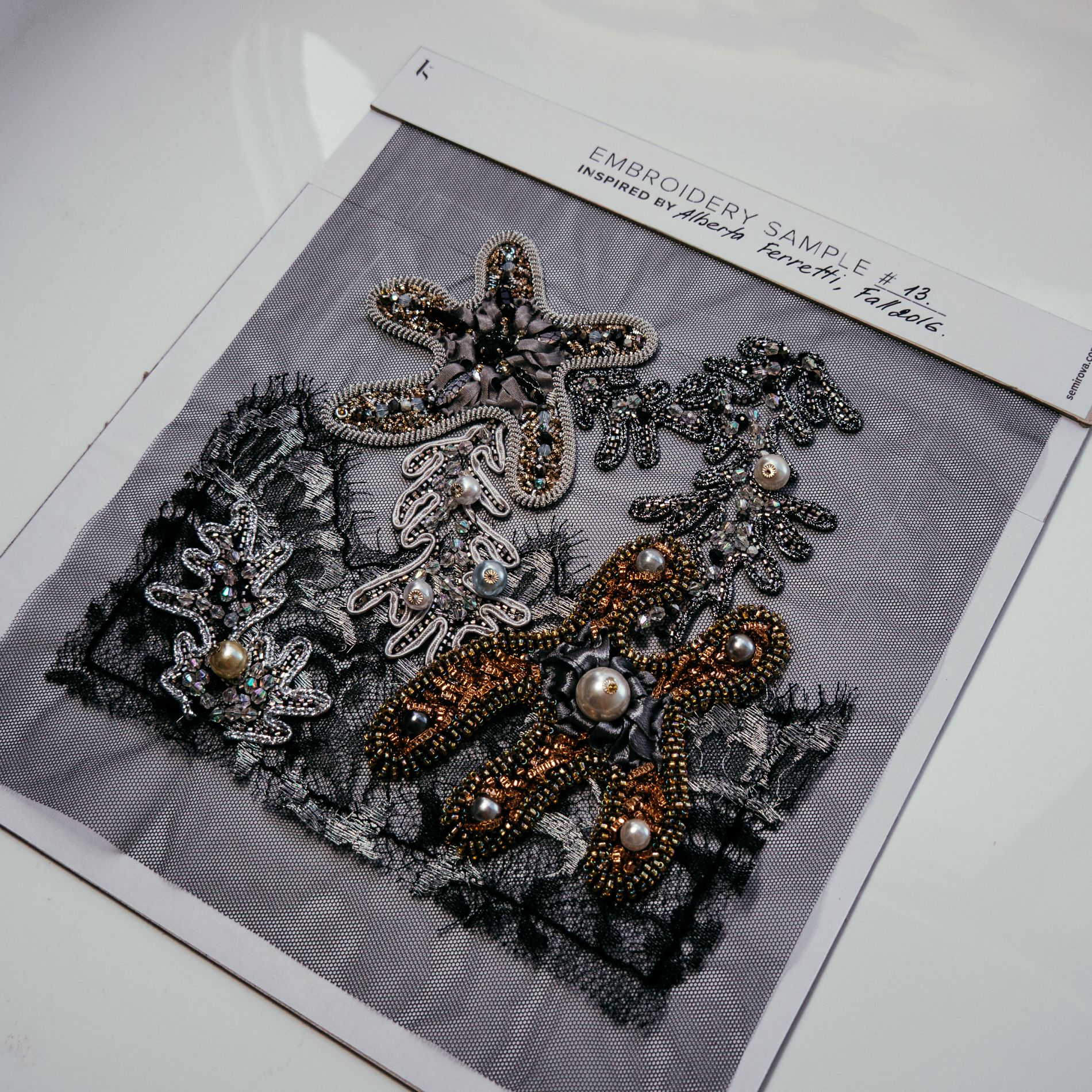 Alberta Ferretti Couture Embroidery Study – Metallic & Lace Motifs Luneville embroidery sample inspired by Alberta Ferretti couture, featuring layered metallic motifs, pearls, beads, and lace appliqué on sheer tulle.