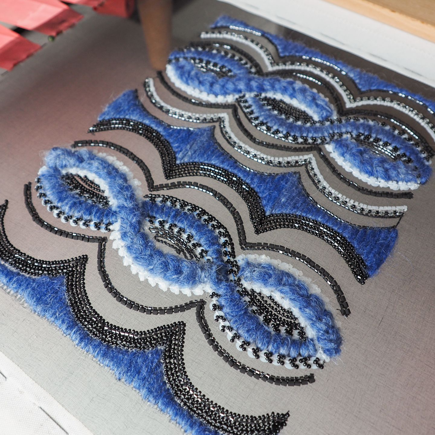 Chanel Pre-Fall 2018 Embroidery Study – Scalloped Pattern Luneville embroidery sample inspired by Chanel Autumn/Winter 2018 Pre-Fall, with blue mohair loops and dense black beadwork forming scalloped bands on a sheer base.