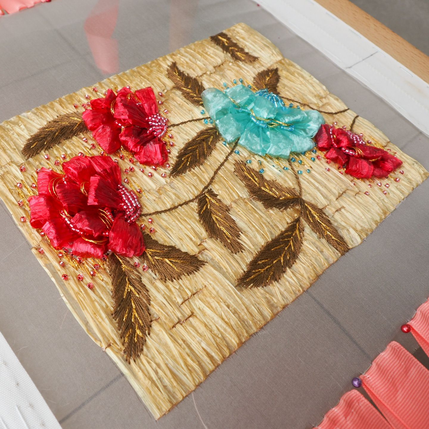 Givenchy 1962 Raffia Couture Embroidery Study Couture embroidery sample inspired by a 1962 Givenchy evening dress, featuring a raffia-stitched base with dimensional flowers, beaded details, and embroidered leaves.