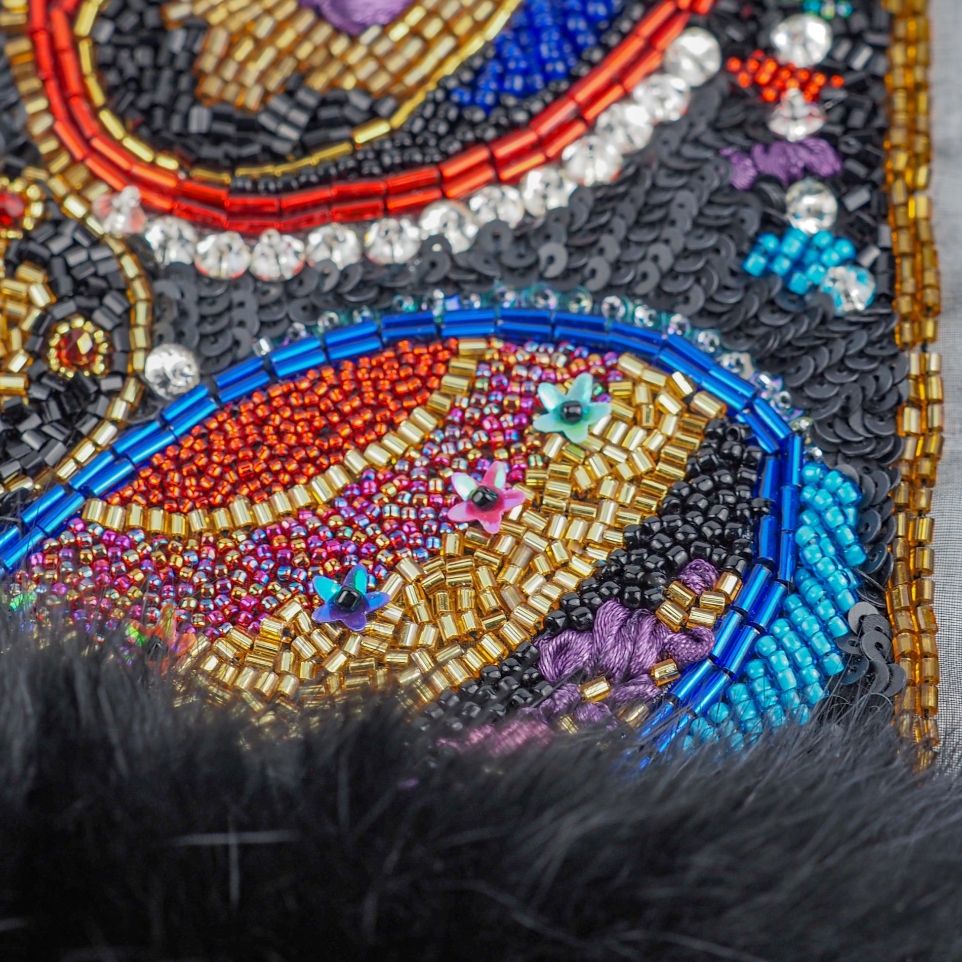 Oscar de la Renta 1987–88 Couture Embroidery – Detail View Close-up of couture embroidery inspired by Oscar de la Renta Fall/Winter 1987–88, showing dense beadwork with red, gold and blue seed beads, bugle beads, sequins and black faux fur trim.