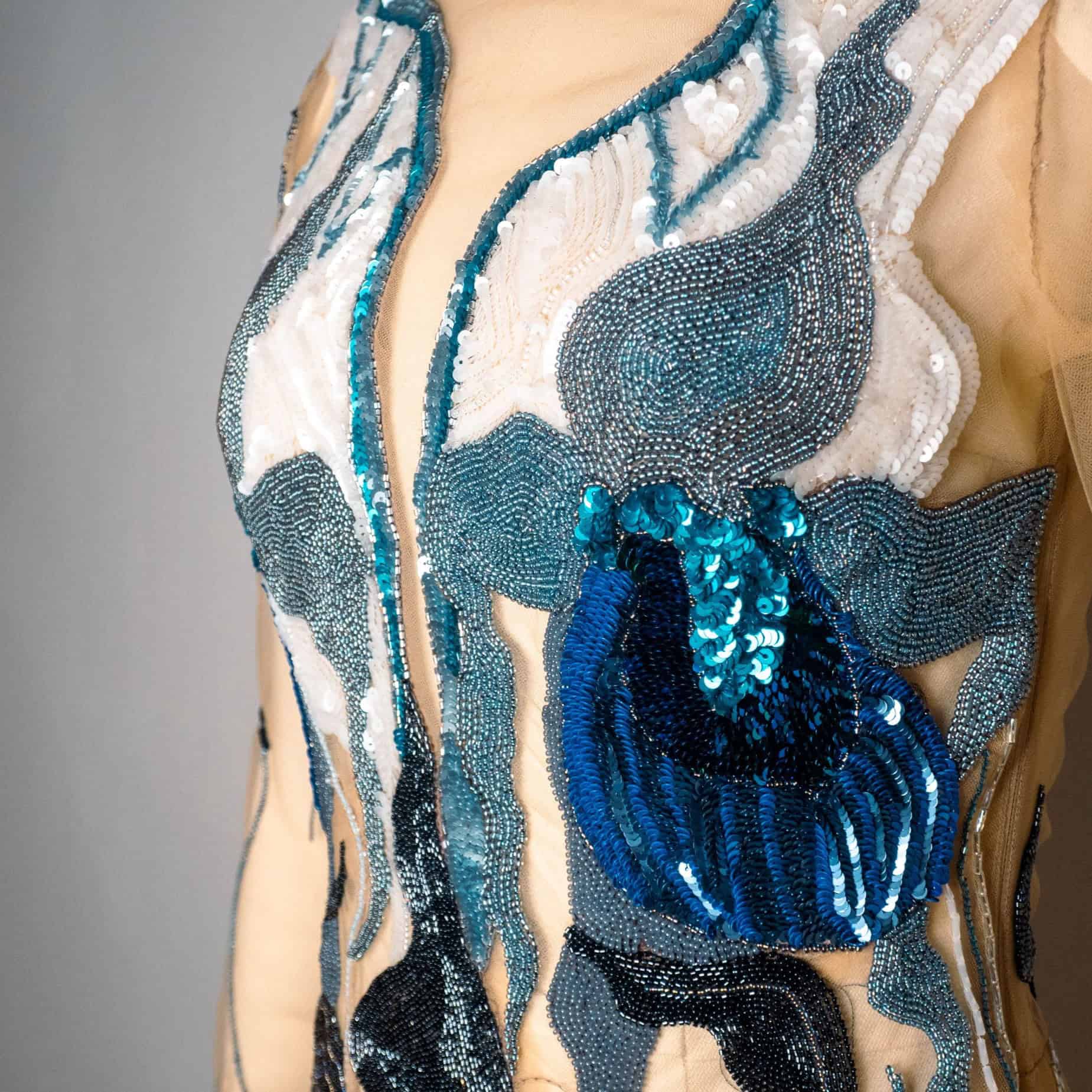 Lady Slipper Couture Dress – Orchid Embroidery Detail Detailed view of an embroidered Lady Slipper orchid motif on Ksenia Semirova’s sheer couture dress.