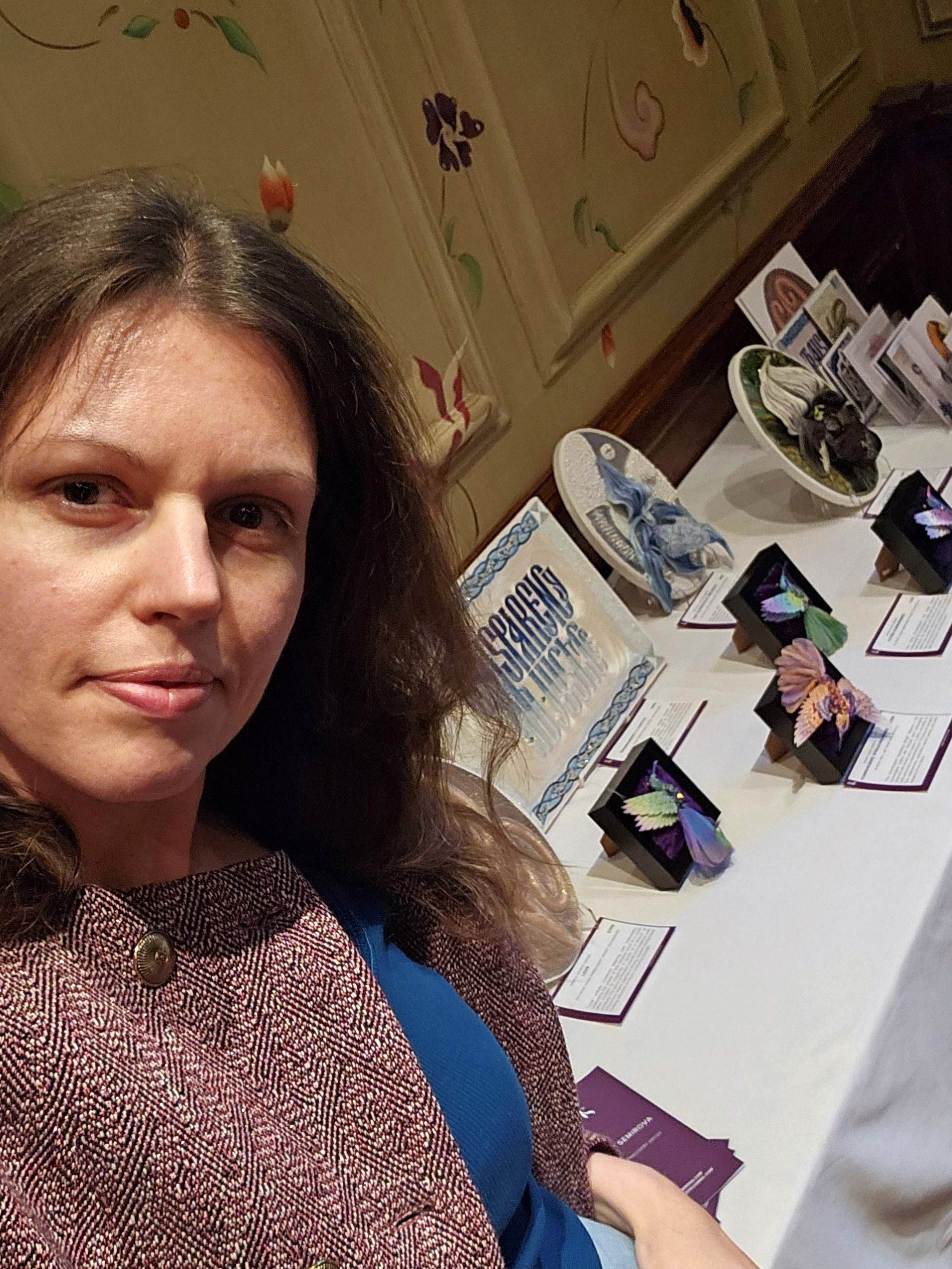Setting up for HelvetArt Reading Ksenia Semirova with her hummingbird and textile artworks displayed at the HelvetArt Art Fair in Reading