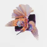 Discover the Hummingbird Spreading Wings Wall Panel and Brooch, a stunning piece of hummingbird artwork. Handcrafted by a hand embroidery artist from Hove, UK, it combines luxurious fabrics and versatile design.