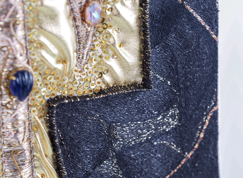 Believe – Embroidery Detail in Black and Gold by Ksenia Semirova | Ksenia Semirova. Embroidery art Close-up of black and gold textile detail from Believe by Ksenia Semirova, showing precise goldwork embroidery with geometric composition.
