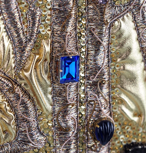 Believe – Goldwork Embroidery Detail with Crystals and Cord | Ksenia Semirova. Embroidery art Close-up of Believe by Ksenia Semirova showing goldwork embroidery with metallic threads, crystals, and cord outlining the Vyaz lettering.