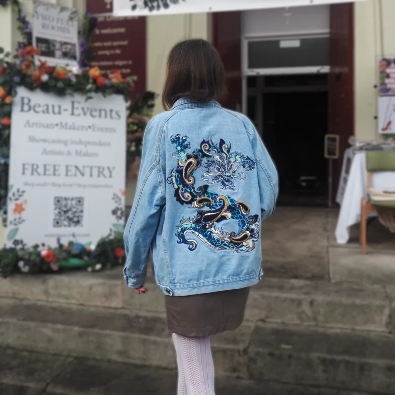 Hand-embroidered dragon denim jacket with velvet, beads, and vintage sequins