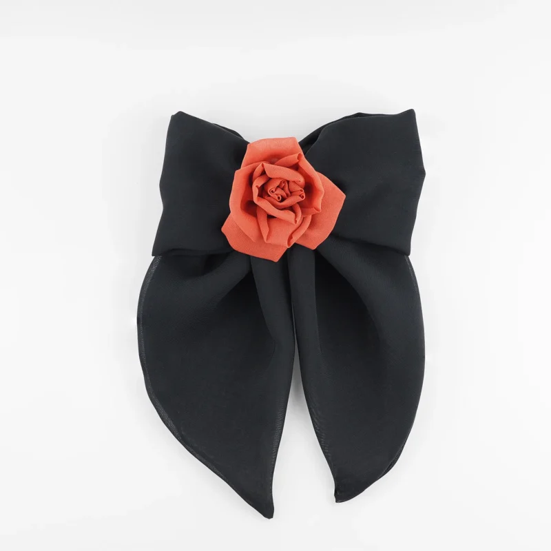 A handmade hair clip featuring a large black chiffon bow measuring approximately 16x25 cm, adorned at the center with a single red silk rose about 6 cm in diameter. The accessory combines bold black and vibrant red colors, showcasing elegant craftsmanship suitable for gothic fashion or evening wear.