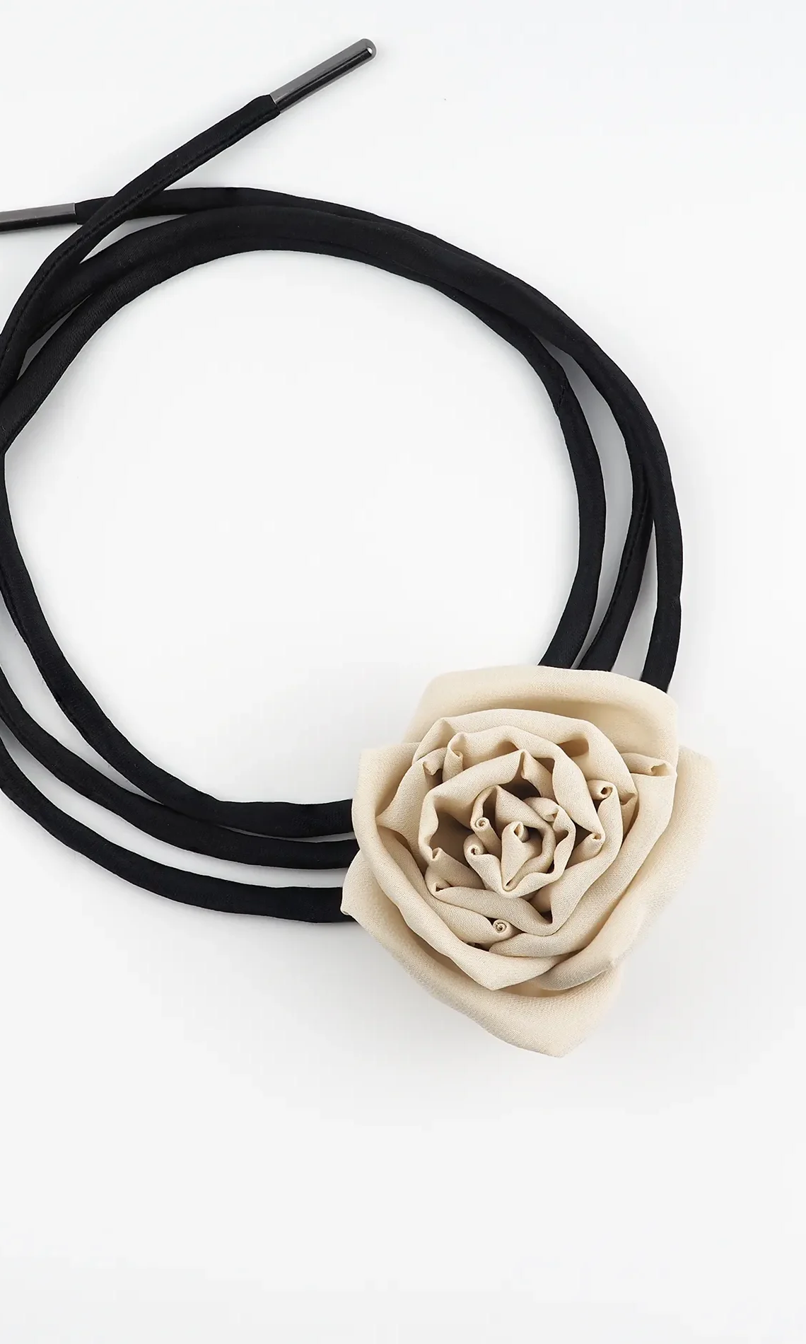 Image of a handmade nude silk rose choker featuring a handcrafted silk rose centerpiece with adjustable black satin lace, perfect for day-to-night styling