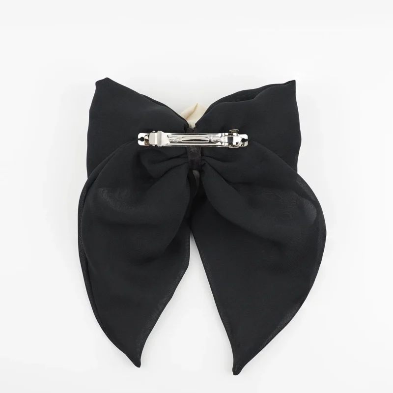 Back view of a black chiffon bow hair clip with a secure silver clip fastening, designed for comfort and durability in elegant hairstyles