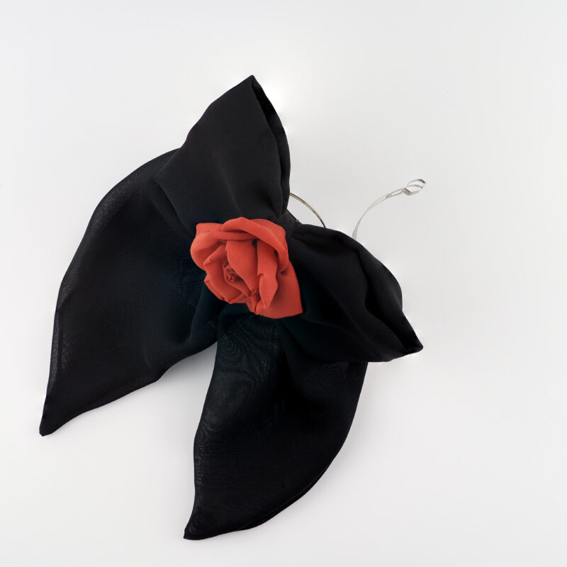 Black chiffon bow hair clip with a vibrant red chiffon rose centerpiece, showcasing a bold and elegant handmade design for versatile hairstyles and statement looks