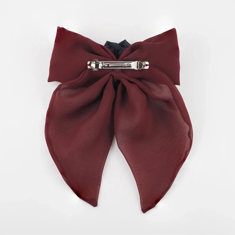 Back view of a maroon chiffon bow hair clip with a secure silver clip fastening, designed for comfort and durability in elegant hairstyles