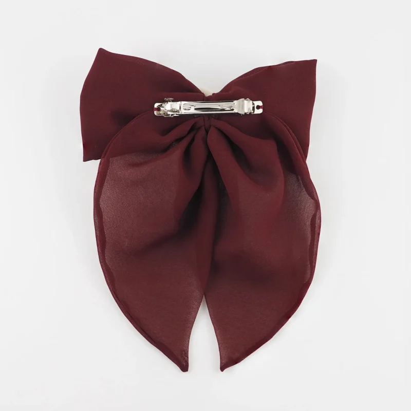 Back view of a maroon chiffon bow hair clip with a secure silver clip fastening, designed for comfort and durability in elegant hairstyles