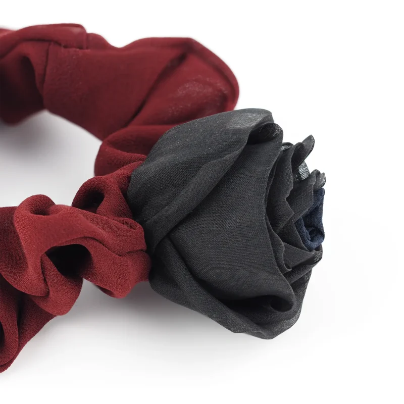 Close-up view of a handmade chiffon scrunchie with silk rose, showcasing the maroon double-layered chiffon band and detailed black silk rose, crafted for a luxurious and elegant touch