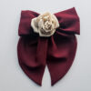 Handmade maroon chiffon bow hair clip with a nude silk rose centerpiece, featuring soft flowing tails and a secure clip design. Perfect for elegant hairstyles, this red bow hair clip adds a sophisticated and handcrafted touch.