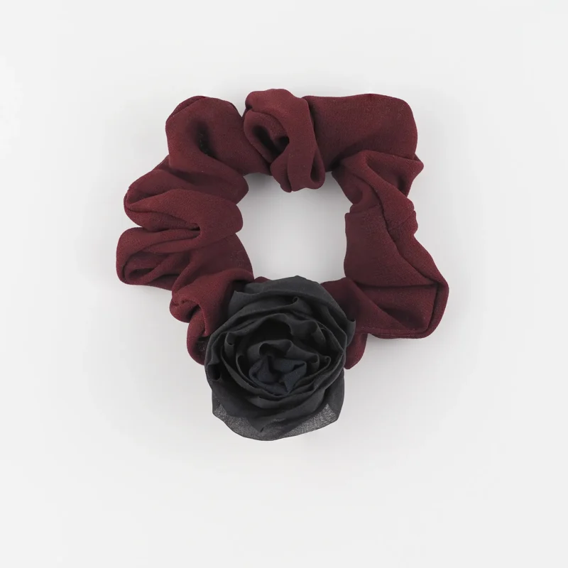 Handmade chiffon scrunchie with silk rose in maroon, featuring a smooth double-layered chiffon design and a bold black silk rose accent, perfect for a luxurious and elegant hair accessory