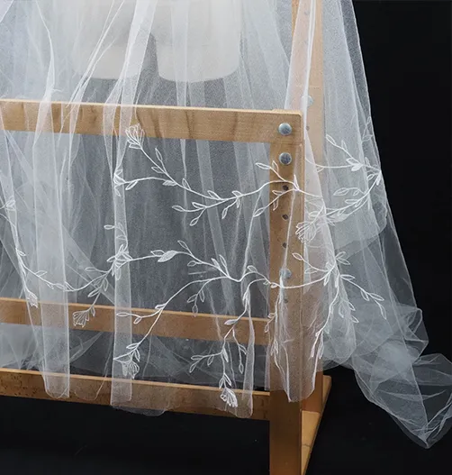 Bespoke wedding veil with hand-drawn floral embroidery in tambour lace shown from the front on mannequin