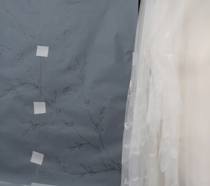 Full-scale floral embroidery motif sketched on paper, used to plan composition for bespoke tambour lace wedding veil.