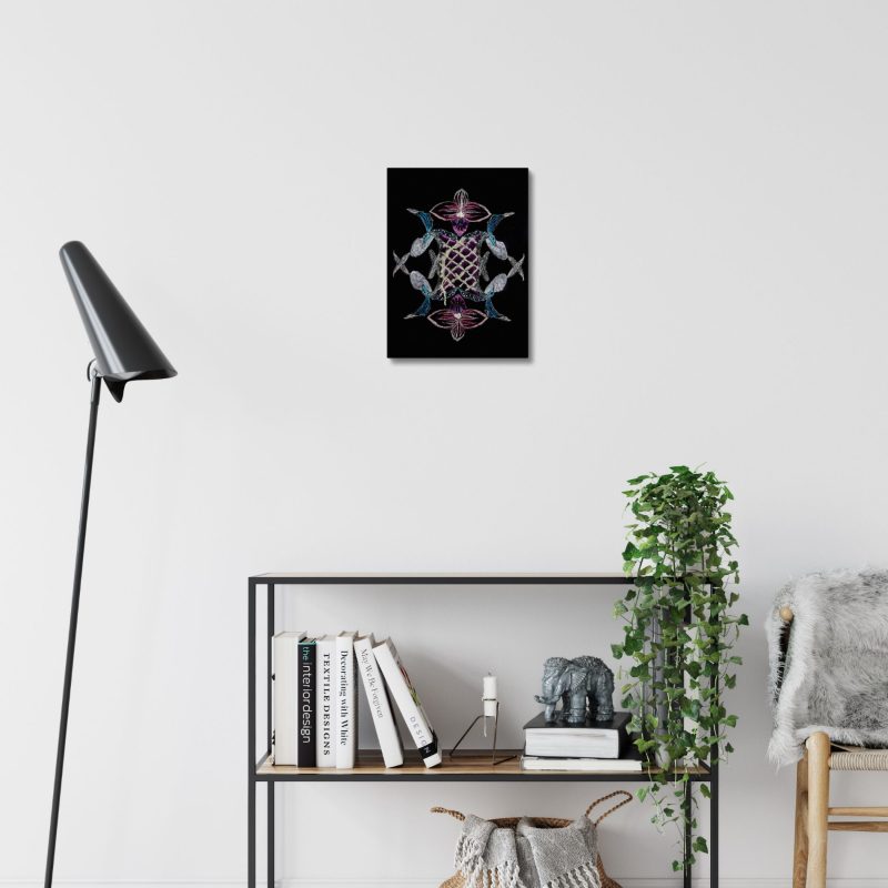 One-of-a-kind orchid embroidered artwork by Ksenia Semirova displayed on a white wall above books and a ceramic mug, in a modern interior setting