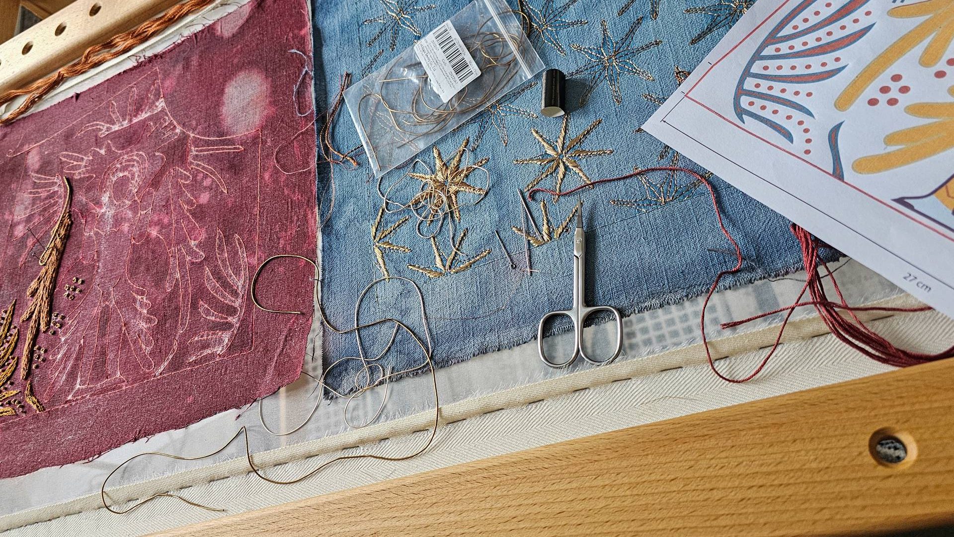 Cosplay Embroidery Commission Costume Panel Work in Progress | Ksenia Semirova. Embroidery art Cosplay embroidery commission showing gold star embroidery and design sketches on red and blue fabric panels, work in progress for a competition costume