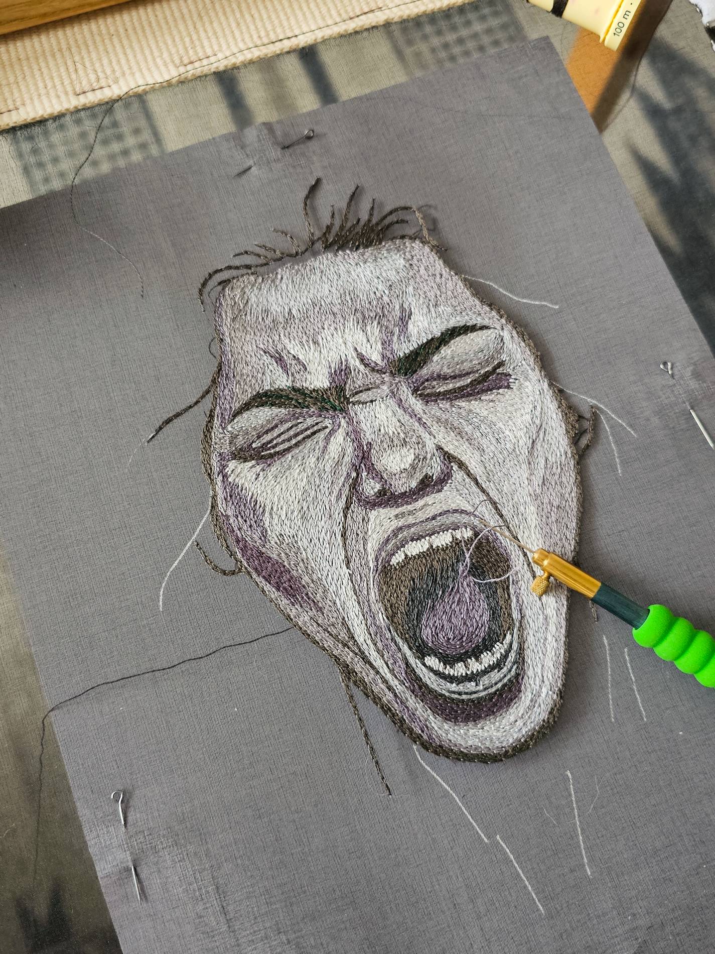 Cosplay Embroidery Commission Expressive Portrait Stitching | Ksenia Semirova. Embroidery art Detailed hand embroidery portrait showing an expressive screaming face in progress, created as part of a cosplay embroidery commission for costume design.