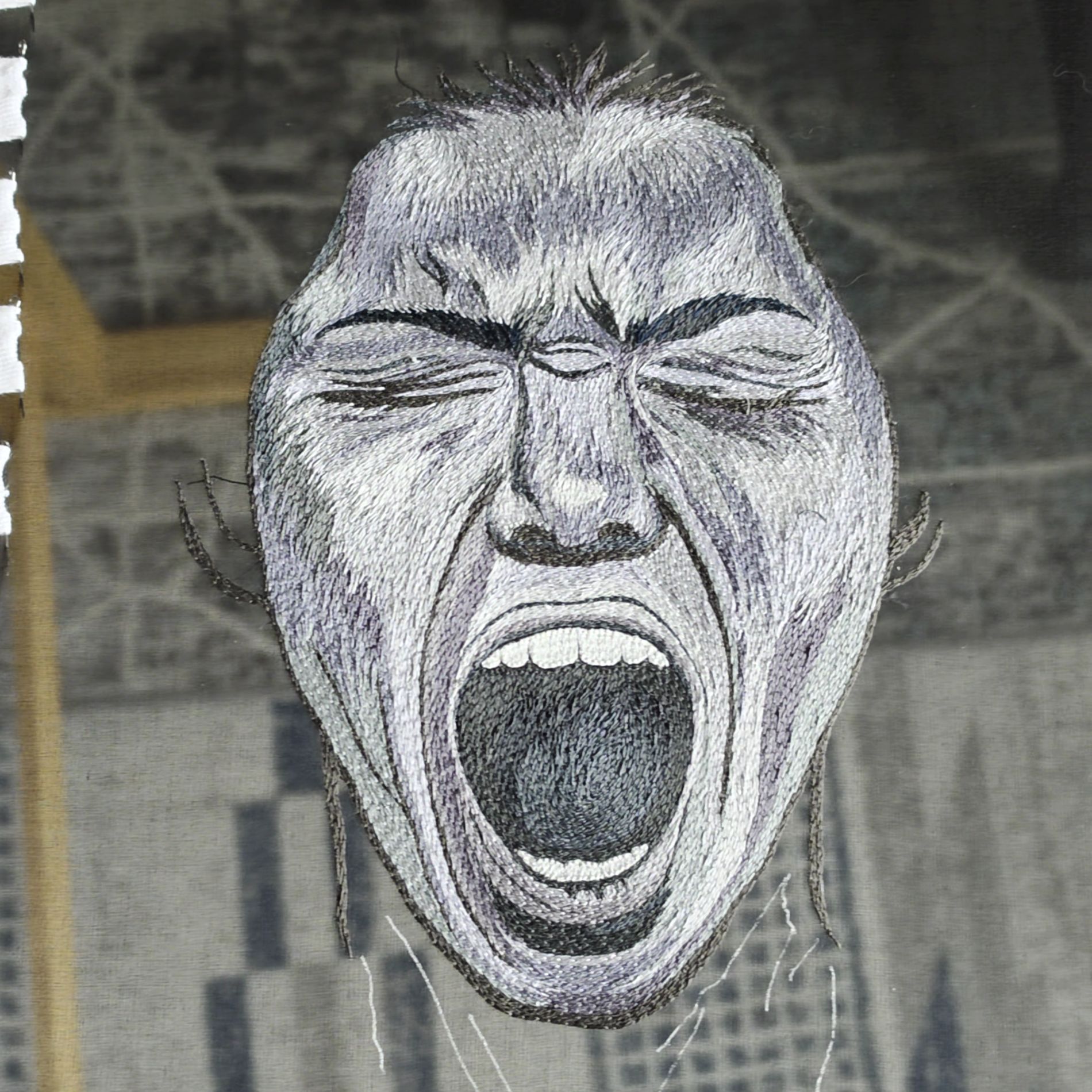 Hand embroidered portrait in progress for Despair from the Power of No series, showing a screaming face stitched in grey, black, and white threads.