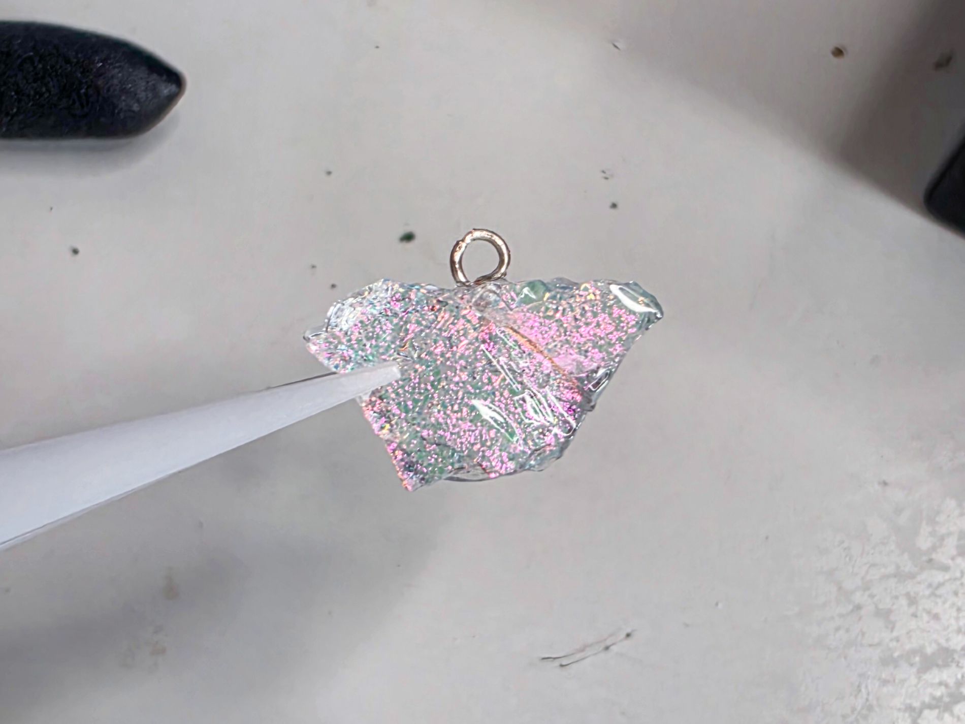Handmade dichroic glass nugget with metal attachment loop, created by Naomi Jacques for the To the Moon and Back necklaces.