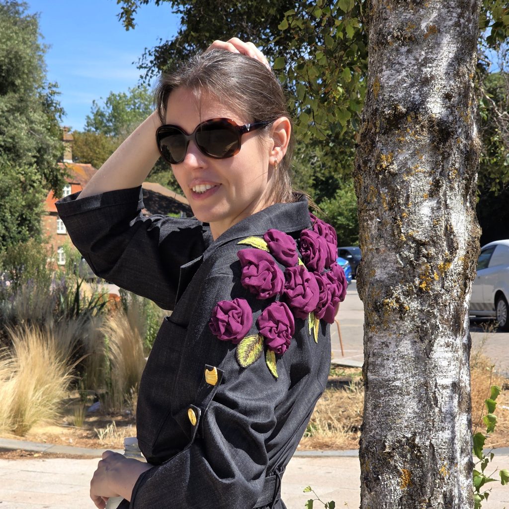 Home 12 Black Rose Jumpsuit embellished with dimensional purple textile roses and embroidered leaves from the Rose Jumpsuit course.