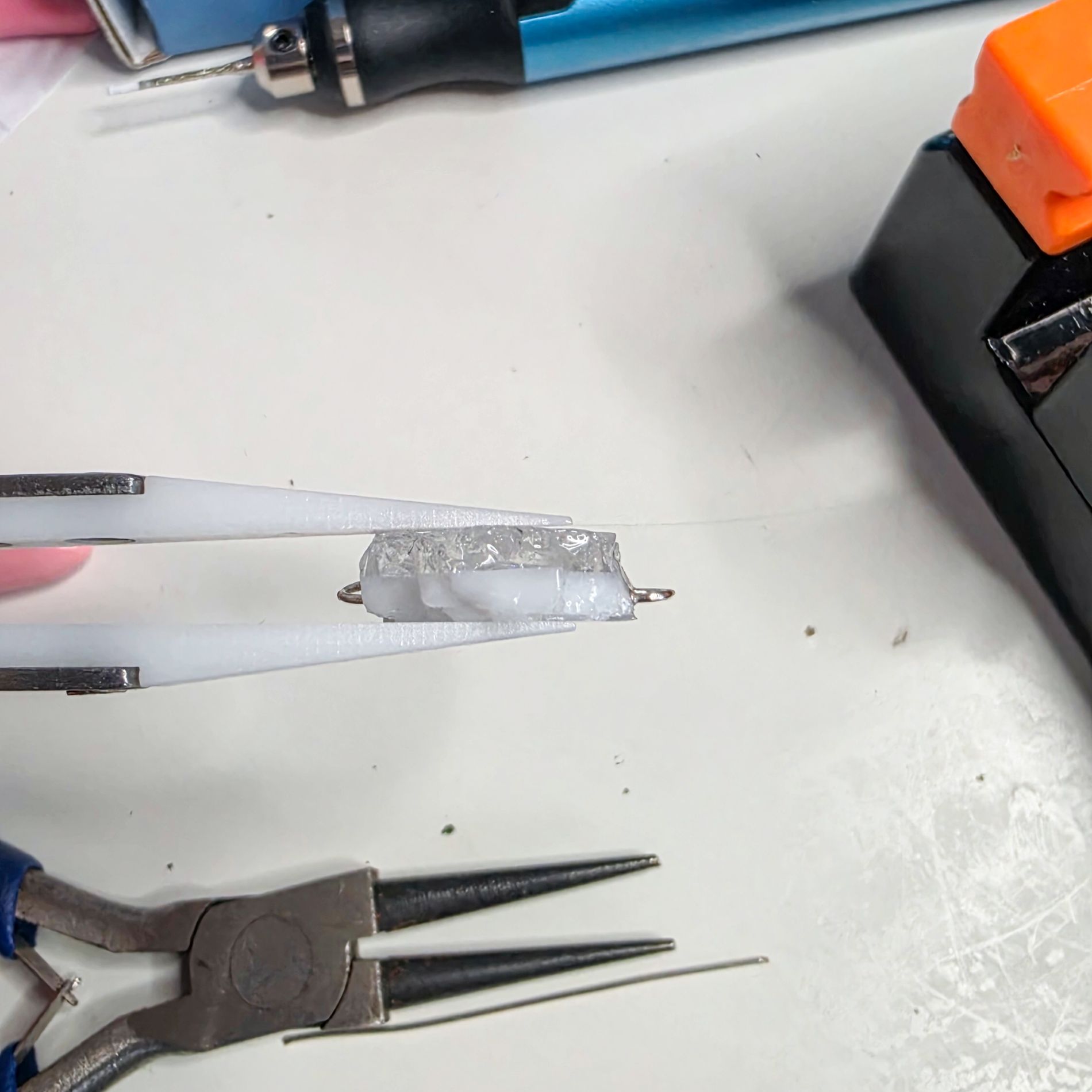 Handmade glass element being prepared for the To the Moon and Back collaborative necklace.